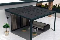 Terrasse d'une maison recouvert de pergola solaire noir sous le soleil